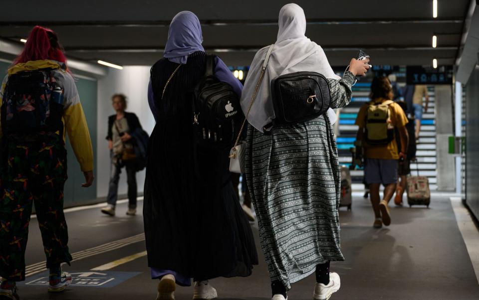 Women wear abayas as they walk in an underpass in Nantes, western France, this week