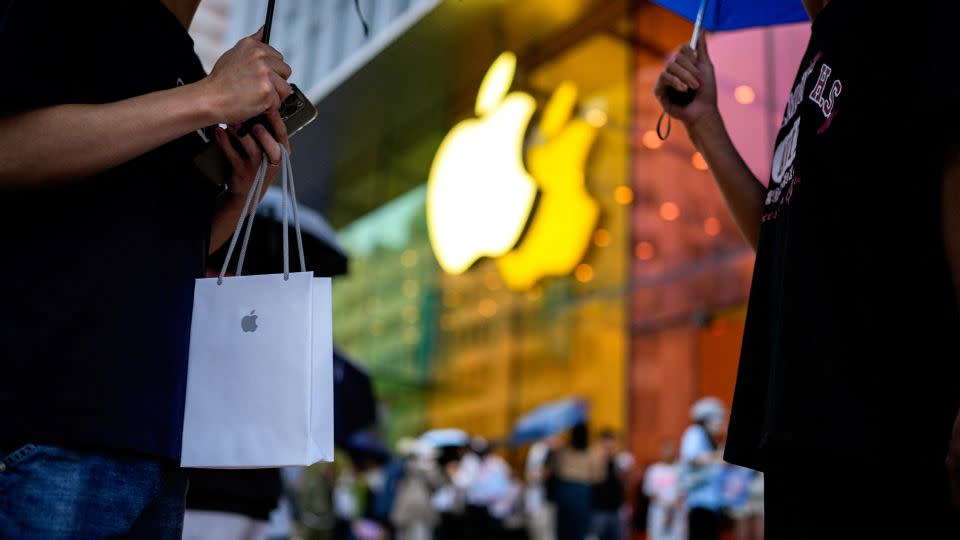 A man holds a bag with a new iPhone on September 22, 2023 when Apple's iPhone 15 went on sale in Shanghai, China . - Aly Song/Reuters