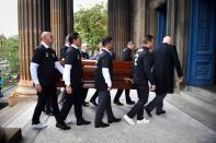 Pallbearers, wearing a number two shirt with Ricksen's name written on them, carry the coffin of the former Dutch footballer (Photo by Andy Buchanan / AFP)