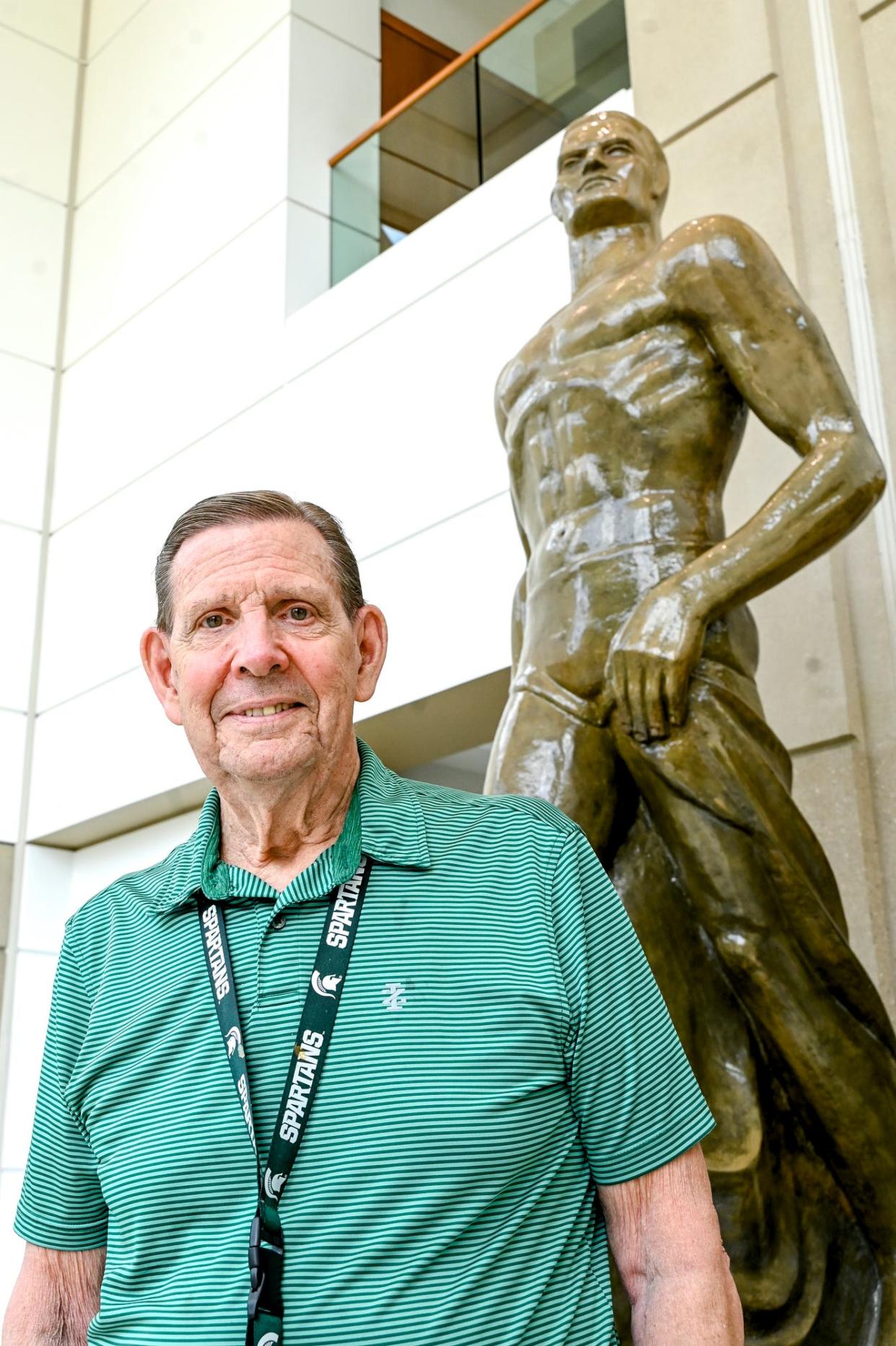 Cyrus Stewart, one of the first Sparty mascots, poses next to the Sparty statue on Wednesday, June 15, 2023, at Spartan Stadium on the Michigan State University campus in East Lansing.