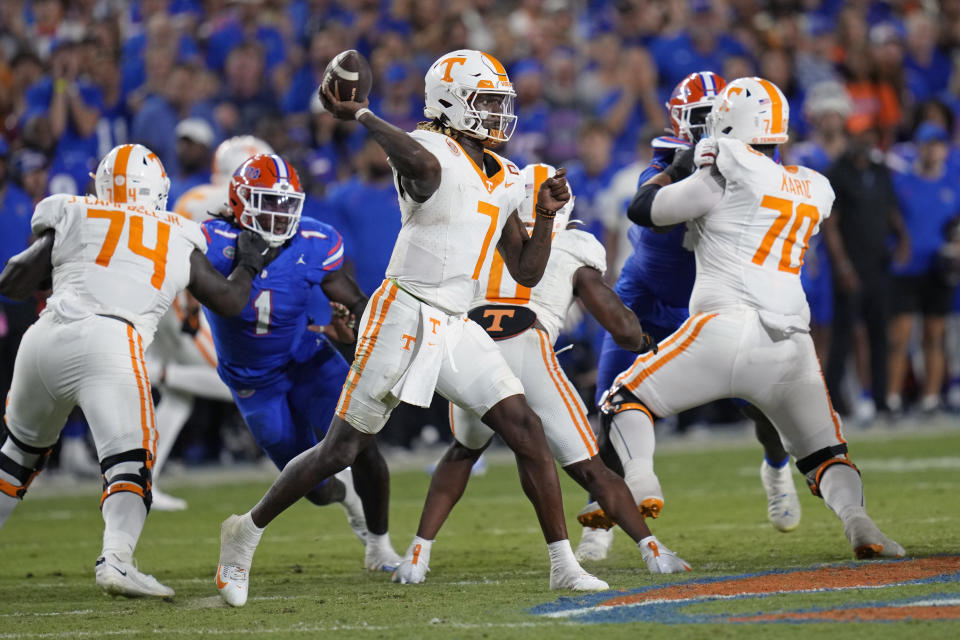 Tennessee quarterback Joe Milton III (7) throws a pass as he is rushed by Florida defensive end Princely Umanmielen (1) during the first half of an NCAA college football game, Saturday, Sept. 16, 2023, in Gainesville, Fla. (AP Photo/John Raoux)
