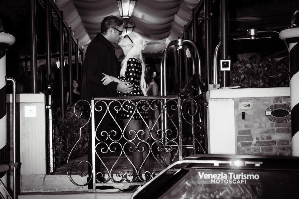 Lady Gaga and Michael Polansky kiss outside a hotel.