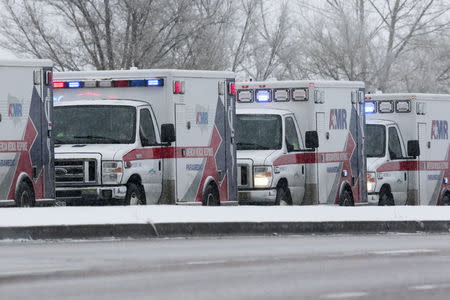 Ambulances wait on a road leading to a Planned Parenthood center after reports of an active shooter in Colorado Springs, November 27, 2015. REUTERS/Isaiah J. Downing