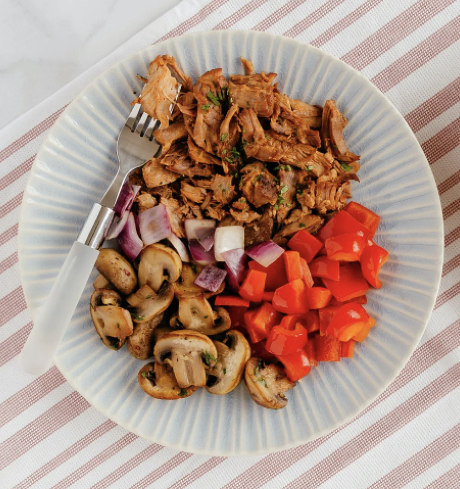 white plate with chicken, mushrooms and red peppers