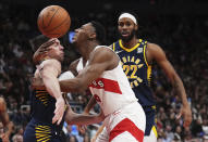 Indiana Pacers guard T.J. McConnell, left, and Toronto Raptors guard RJ Barrett collide during the second half of an NBA basketball game in Toronto on Tuesday, April 9, 2024. (Nathan Denette/The Canadian Press via AP)