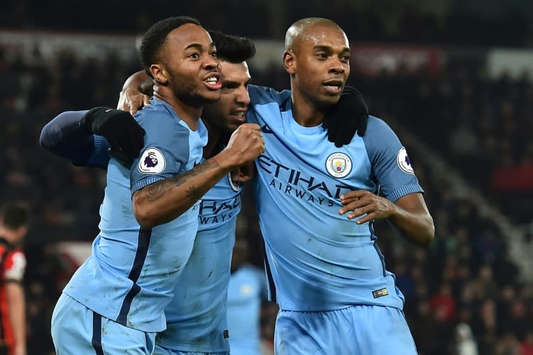 Manchester City's Sergio Aguero (C) celebrates with teammates Raheem Sterling (L) and Fernandinho after scoring a goal during their English Premier League match against Bournemouth, at the Vitality Stadium in Bournemouth, on February 13, 2017