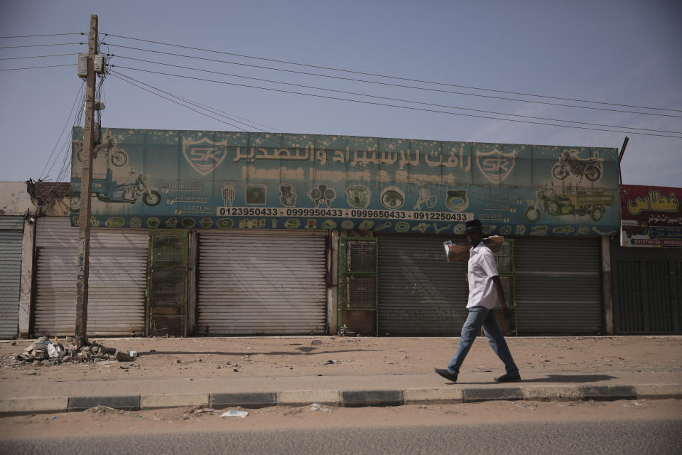 A man drives past shuttered shops after a military unseated the government earlier this week in Khartoum, Sudan, Thursday.. Oct 28, 2021. Gen Abdel-Fattah Buran dissolved the transitional government and detained the prime minister, many government officials and political leaders in a coup condemned by the U.S. and the West. The military allowed Hamdok to return home Tuesday after international pressure for his release. (AP Photo/Marwan Ali)