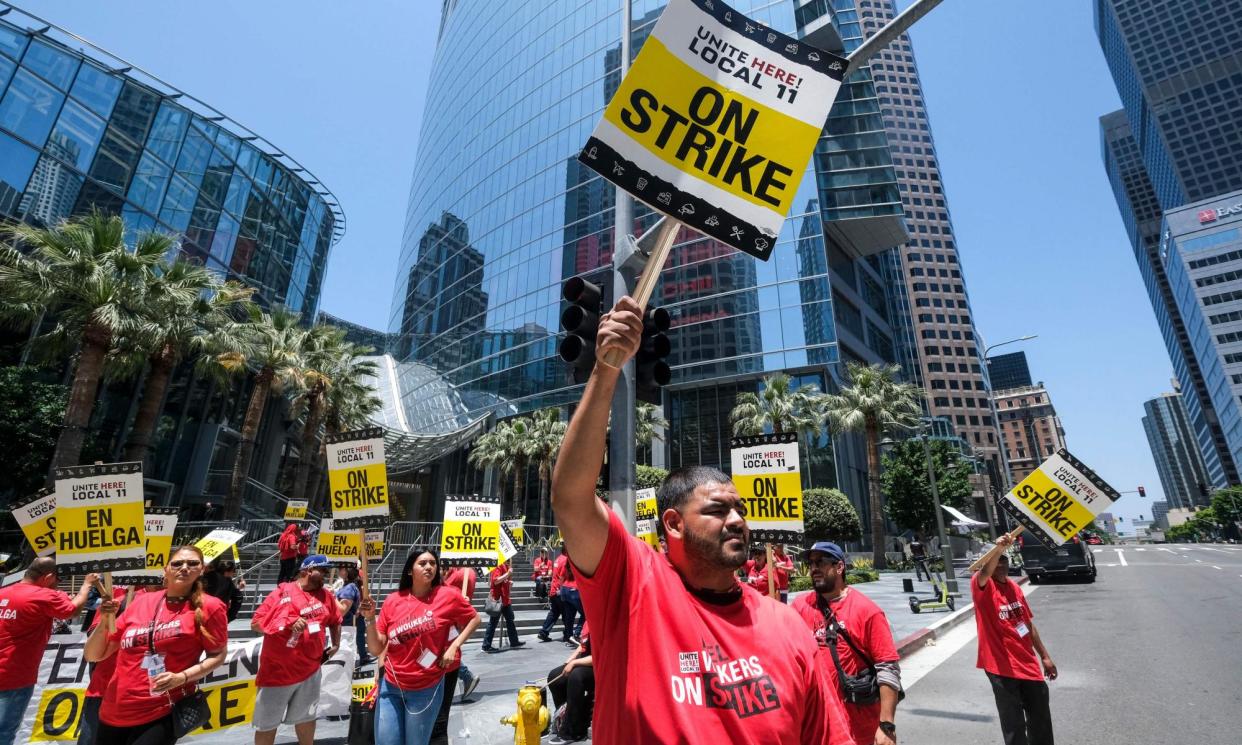 <span>Striking hotel workers walk the picket line outside the Intercontinental Hotel in Los Angeles, California, in July 2023.</span><span>Photograph: Ringo Chiu/AFP/Getty Images</span>