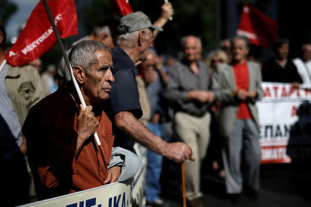 A Greek pensioner holds a flag during a demonstration against planned pension cuts in Athens, Greece, October 3, 2017. REUTERS/Alkis Konstantinidis
