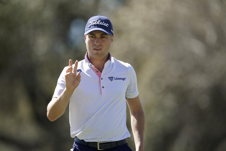 Justin Thomas waves after putting on the sixth green in the second round of the Dell Technologies Match Play Championship golf tournament, Thursday, March 24, 2022, in Austin, Texas. (AP Photo/Tony Gutierrez)