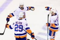 New York Islanders defenseman Andy Greene (4) celebrates his goal with teammates Brock Nelson (29) and Anthony Beauvillier (18) during first-period NHL Stanley Cup Eastern Conference playoff hockey game action against the Philadelphia Flyers in Toronto, Monday, Aug. 24, 2020. (Frank Gunn/The Canadian Press via AP)