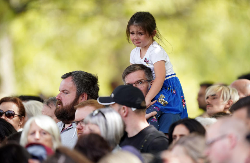 Members of the public on the Mall listen to the State Funeral of Queen Elizabeth II, held at Westminster Abbey, London. Picture date: Monday September 19, 2022.