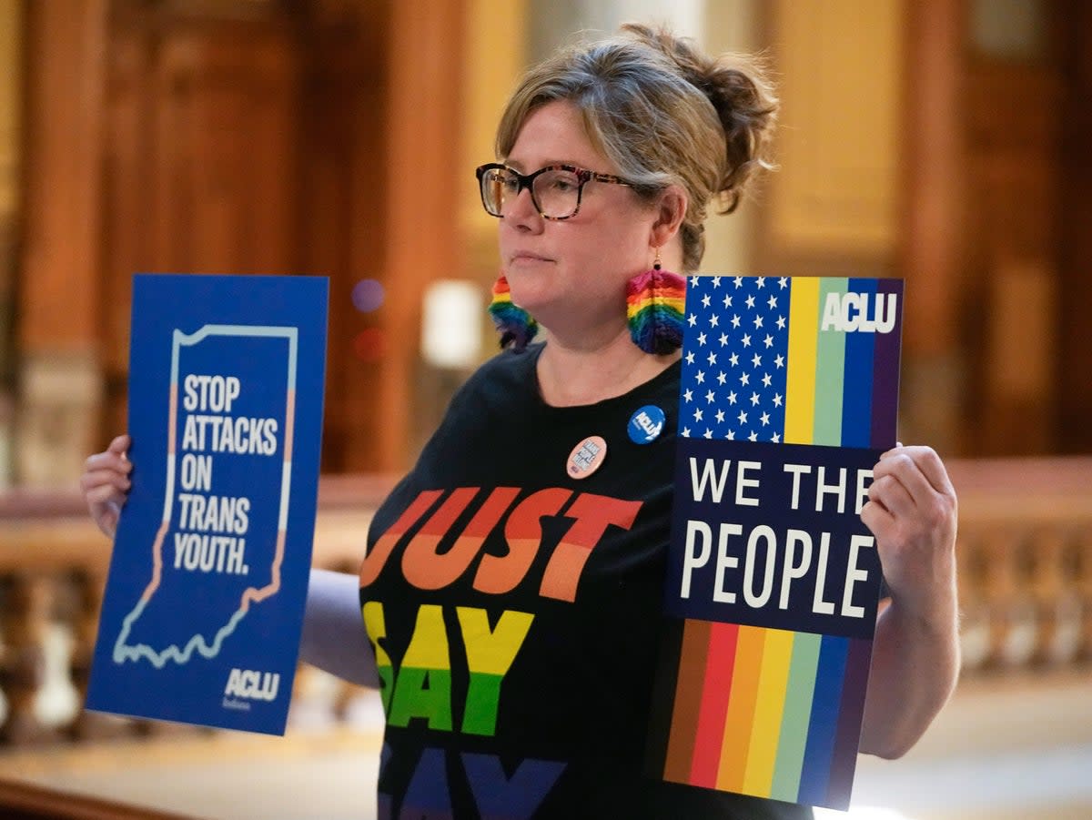 A trans rights protester outside the Indiana Statehouse on 22 February 2023 (AP Photo/Darron Cummings)