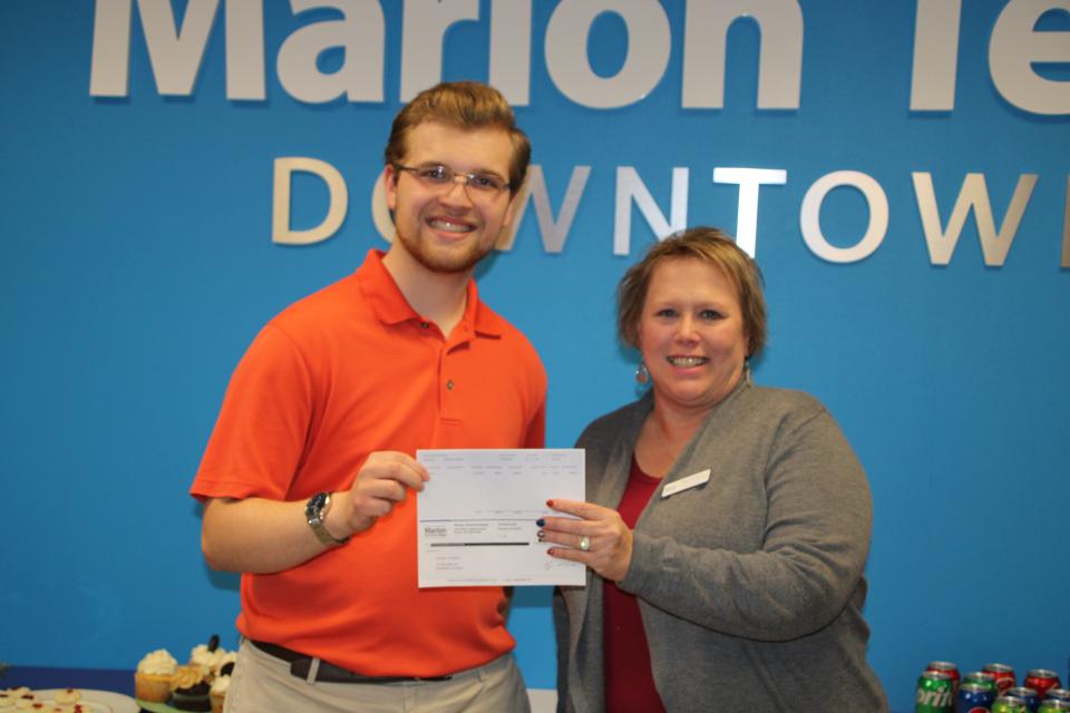 UpSkill-A-Thom participant Nathan Wright, left, receives a check from Tami Galloway of Marion Technical College after placing third in the 16 to 24 year old age division of the event.