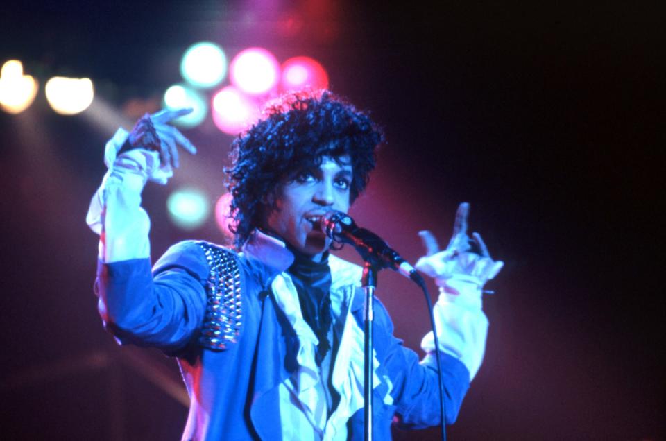 Prince performs onstage during the 1984 Purple Rain Tour.