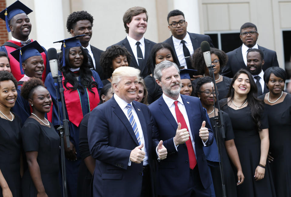 President Donald Trump with Liberty University President Jerry Falwell Jr. in front of a choir at the school's&nbsp;commencement ceremony in Lynchburg, Virginia, May 13, 2017. Trump delivered his first commencement address as president at Liberty. (Photo: Steve Helber / ASSOCIATED PRESS)