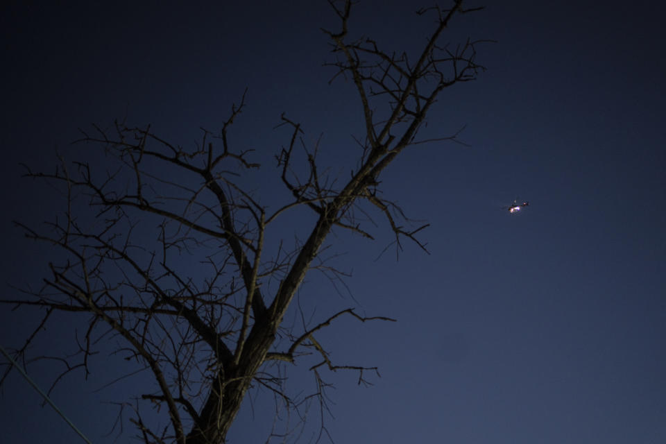 A police helicopter flies over Puerta 8, a low income neighborhood north of Buenos Aires, Argentina, Wednesday, Feb. 9, 2022, where contaminated cocaine may have been sold. A batch of that toxic cocaine has killed at least 23 people and hospitalized many more, according to police. (AP Photo/Rodrigo Abd)