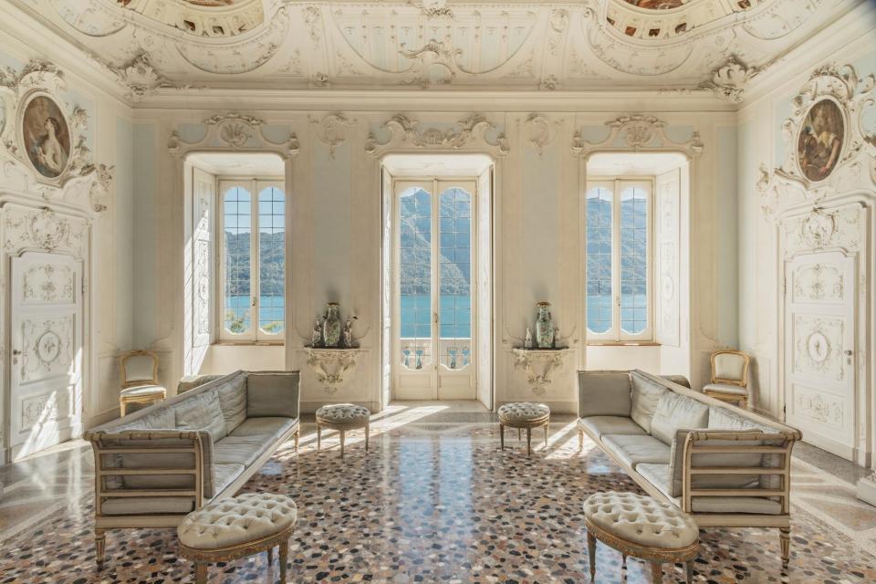 A large parlor with intricately carved walls overlooking Lake Como.