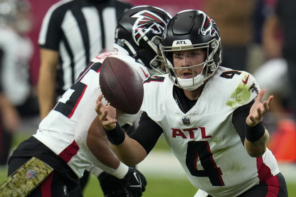 Atlanta Falcons quarterback Taylor Heinicke (4) bobbles the ball against the Arizona Cardinals during the first half of an NFL football game, Sunday, Nov. 12, 2023, in Glendale, Ariz. (AP Photo/Ross D. Franklin)