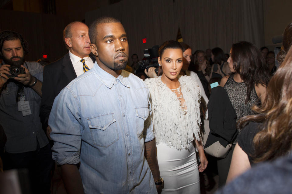IMAGE DISTRIBUTED FOR FIJI WATER - Kanye West, left, and Kim Kardashian attend the FIJI Water-sponsored Marchesa Spring 2013 Fashion Show at Vanderbilt Hall on Wednesday Sept. 12, 2012, in New York. (Photo by Victoria Will/Invision for FIJI Water /AP Images)