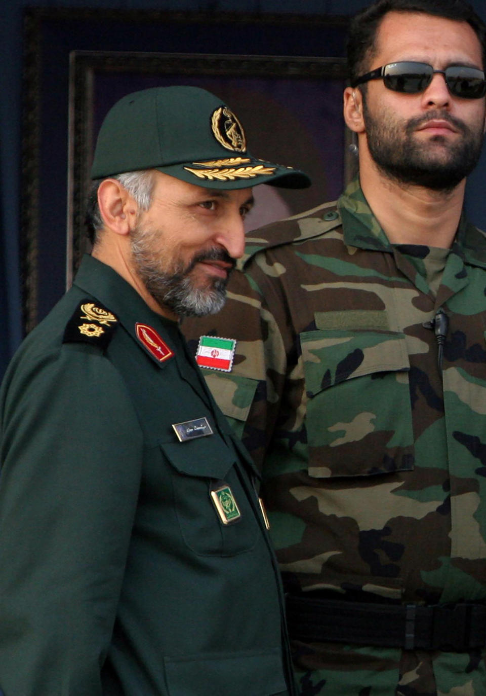 FILE-- In this Sunday, Nov. 26, 2006, file photo, Brig. Gen. Mohammad Hosseinzadeh Hejazi, left, attends a military parade in Tehran, Iran. Brig. Gen. Hejazi, deputy commander of the Quds, or Jerusalem, force of Iran's paramilitary Revolutionary Guard, has died, the Guard Corps announced on Sunday, April 18, 2021. The unit is an elite and influential group that oversees foreign operations, and Hejazi helped lead its expeditionary forces and frequently shuttled between Iraq, Lebanon and Syria. (AP Photo/Vahid Salemi, File)