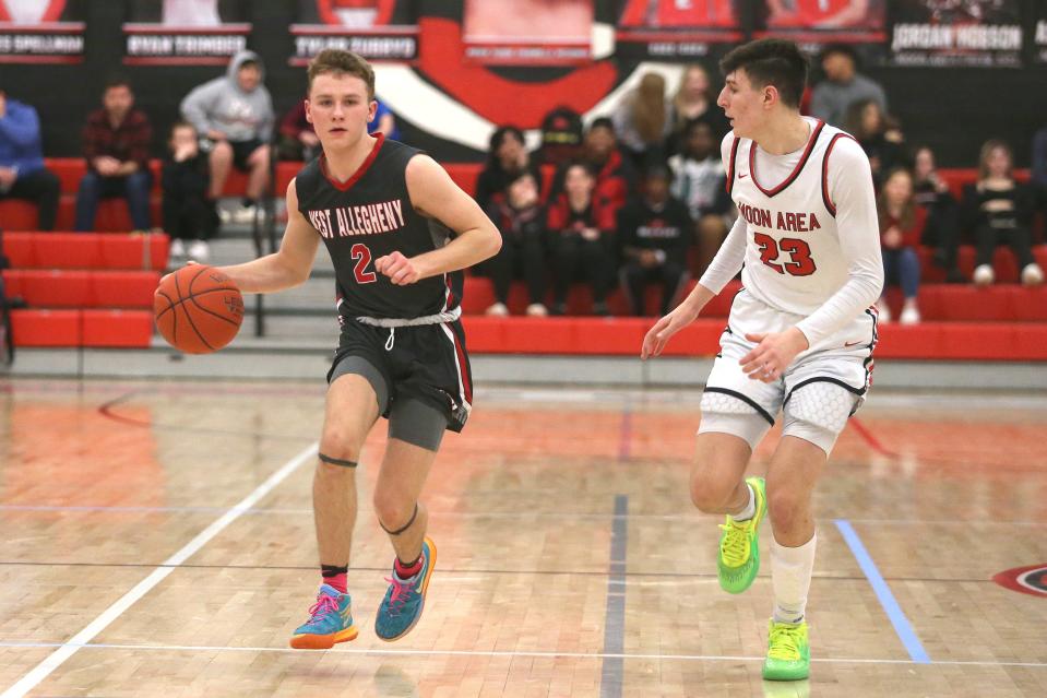 West Allegheny's Ty Blatz (2) dribbles downcourt while being guarded by Moon's Michael Santicola (23) during the second half Tuesday night at Moon Area High School.