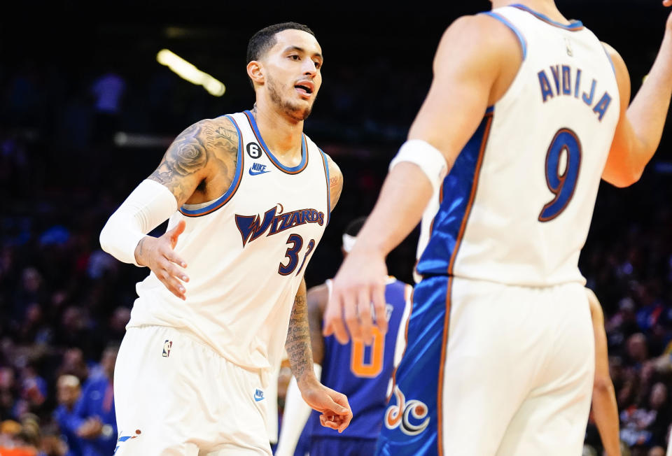 Washington Wizards' Kyle Kuzma gives a high five to Dani Avdija (9) after Kuzma put the Wizards up over the Phoenix Suns late in the second half of an NBA basketball game in Phoenix, Tuesday, Dec. 20, 2022. Washington beat Phoenix 113-110. (AP Photo/Darryl Webb)