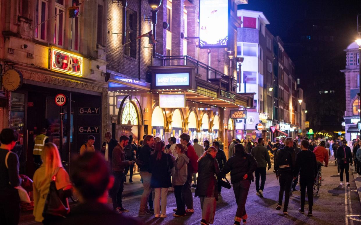 People leave bars and restaturants at closing time in Soho, London, the day after pubs and restaurants were subject to a 10pm curfew - Dominic Lipinski/PA