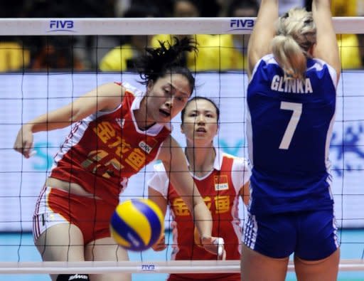 This file photo shows a Chinese player spiking the ball past a Polish competitor during their match at the FIVB 2010 Women's Volleyball World Championships in Tokyo. Experts say China has Olympic medal chances in taekwondo, judo, women's water polo, women's volleyball, women's beach volleyball and trampoline, in which they have numerous world champions