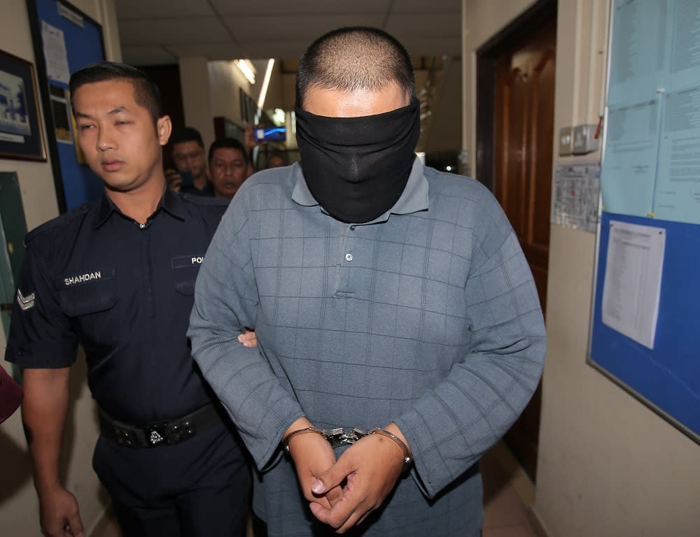 The accused is seen being led to the Session Court in Ipoh January 24, 2020. — Picture by Farhan Najib