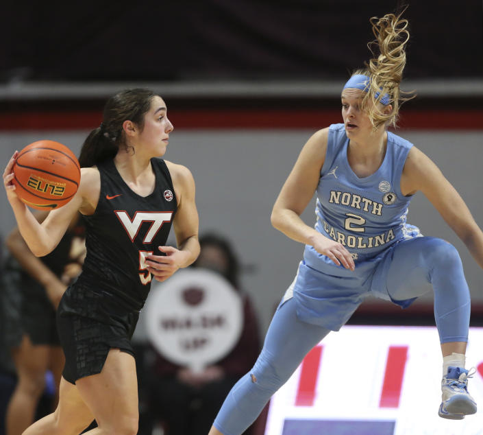 Virginia Tech's Georgia Amoore (5) looks to pass while defended by North Carolina's Carlie Littlefield (2) in the first half of the North Carolina Virginia Tech women's NCAA basketball game in Blacksburg Va., on Saturday, Feb. 12 2022. (Matt Gentry/The Roanoke Times via AP)