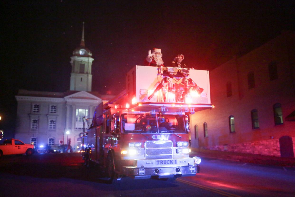 Santa Claus and Mrs. Claus ride on a Columbia Fire and Rescue engine down East 7th Street marking the end of the Columbia Main Street Christmas Parade on Monday, Dec. 2, 2019. (Staff photo by Mike Christen)