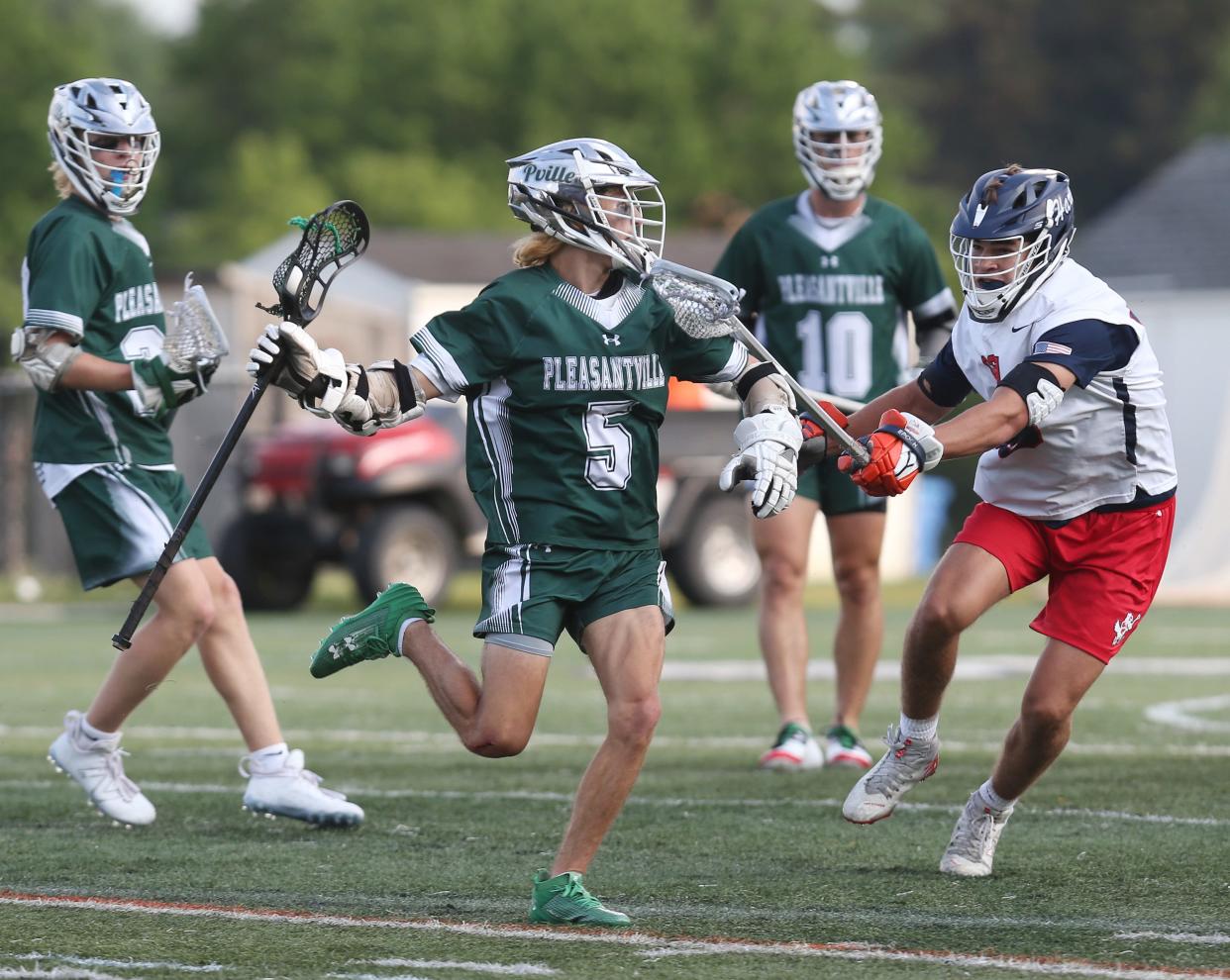 Pleasantville's Erik Coleman (5) tries to drive around fires a Cold Spring Harbor defenders during the boys lacrosse state Class D semifinal at Ford Field on the campus of the University at Albany June 9, 2023. 
