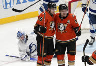 Anaheim Ducks center Derek Grant, center, celebrates his goal with right wing Jakob Silfverberg, right, as Tampa Bay Lightning goaltender Andrei Vasilevskiy lays on the ice during the second period of an NHL hockey game Friday, Jan. 21, 2022, in Anaheim, Calif. (AP Photo/Mark J. Terrill)