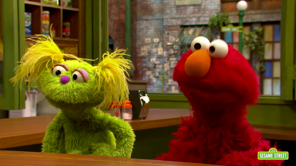 Sesame Street's new muppet Karli pictured with Elmo. Karli has a mother who is struggling with addiction. Source: Sesame Street