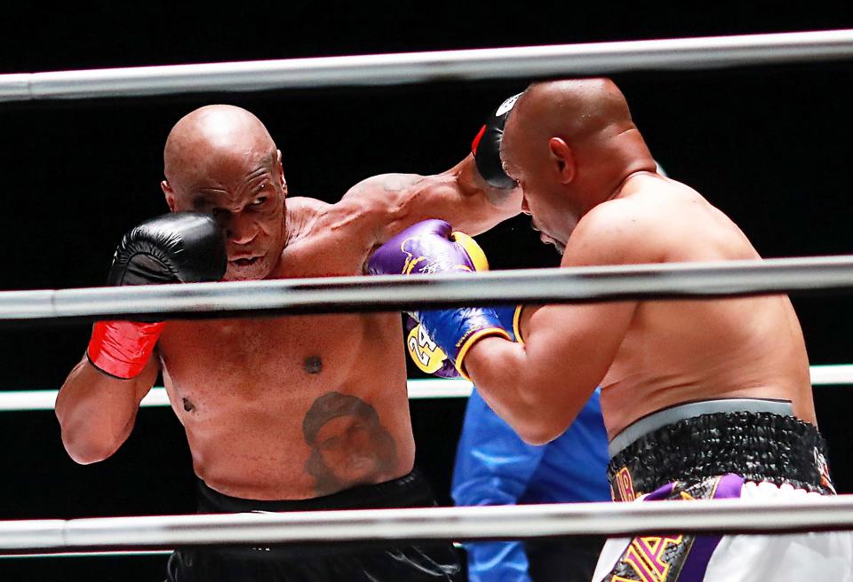 In a photo provided by Triller, Mike Tyson throws a punch during the third round against Roy Jones Jr. in an exhibition boxing bout Saturday in Los Angeles. The bout was unofficially ruled a draw by the WBC judges at ringside. Tyson and Jones fought eight two-minute rounds, and both emerged smiling and apparently healthy from a highly unusual event. [Joe Scarnici/Triller via AP]