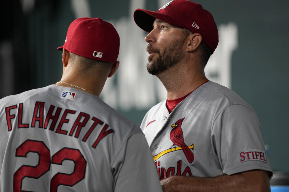 St. Louis Cardinals' Jack Flaherty (22) talks with Adam Wainwright, right, after he was pulled in the sixth inning of a baseball game against the Texas Rangers, Monday, June 5, 2023, in Arlington, Texas. (AP Photo/Tony Gutierrez)