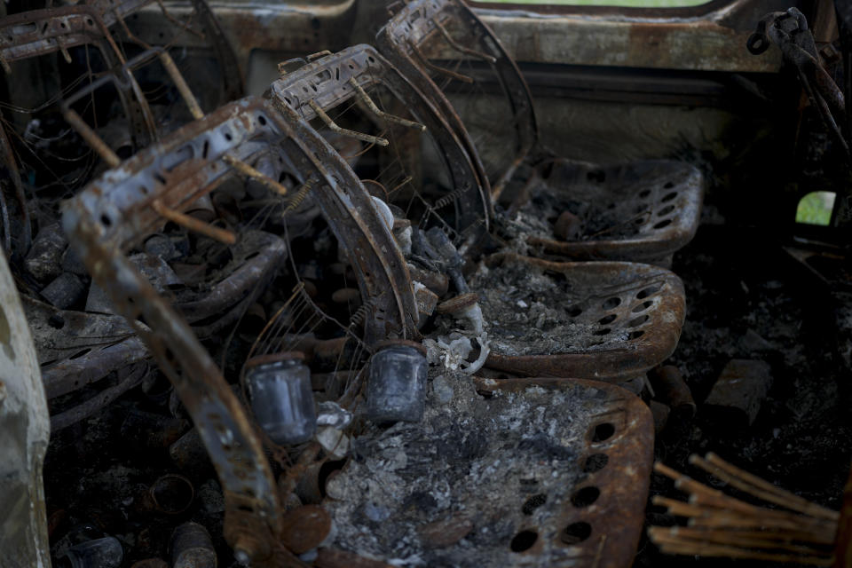 The inside of a wreckage of a burned out van that triggered an anti-tank mine, killing its three occupants, lies by the side of a dirt track in Andriyivka, on the outskirts of Kyiv, Ukraine, Tuesday, June 14, 2022. Russia’s invasion of Ukraine is spreading a deadly litter of mines, bombs and other explosive devices that will endanger civilian lives and limbs long after the fighting stops. (AP Photo/Natacha Pisarenko)