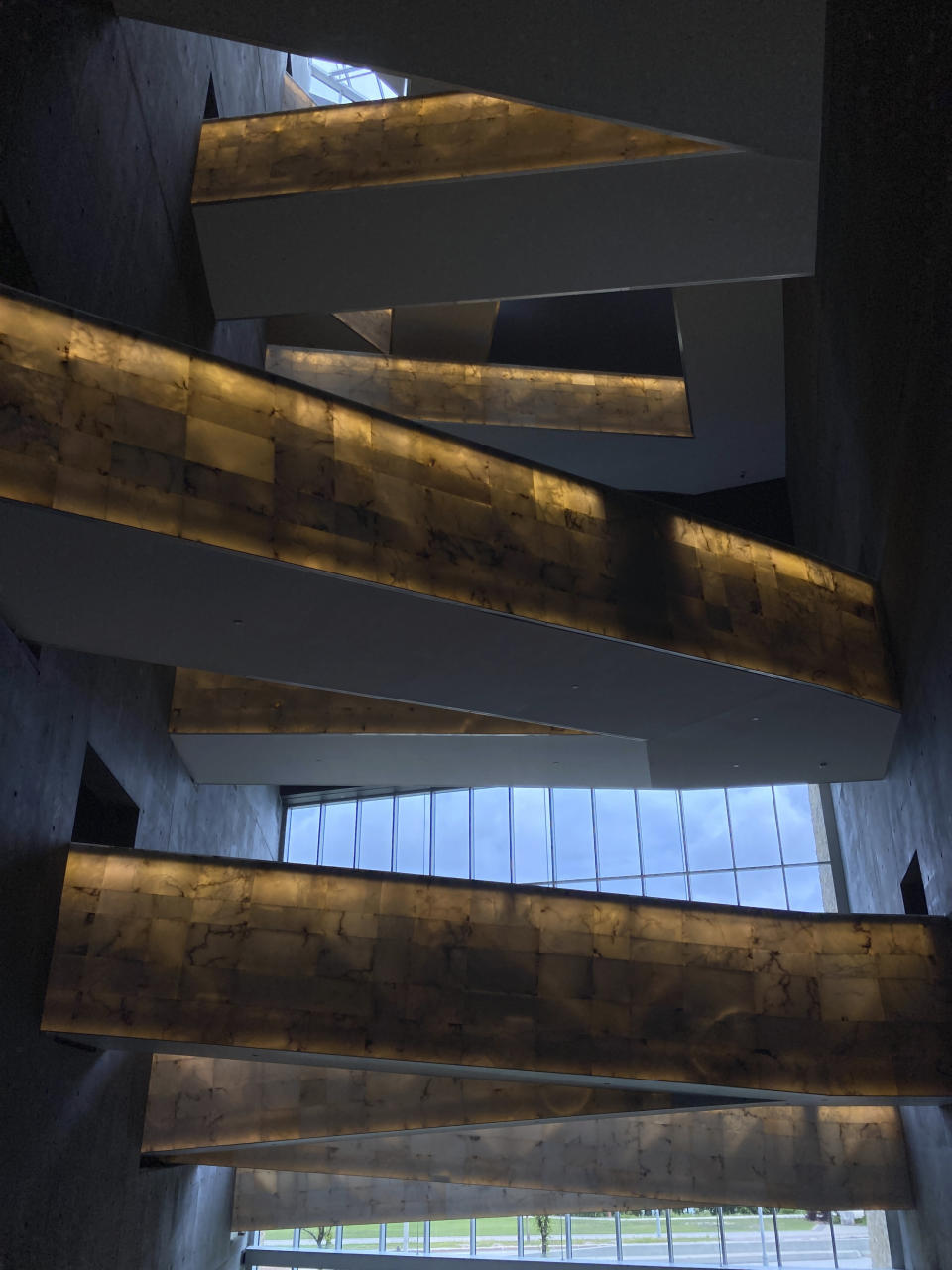 Illuminated walkways take visitors through various floors of the Canadian Museum for Human Rights, created by internationally renowned architect Antoine Predock, in Winnipeg, Manitoba, Aug. 13, 2023. Predock, whose list of credits include award-winning buildings around the world, died Saturday, March 2, 2024 at his home in Albuquerque, according to longtime friends and colleagues. He was 87. (AP Photo/Felicia Fonseca)