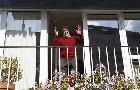 Belgian physicist Francois Englert reacts as he appears at the balcony of his house in Brussels October 8, 2013, after he and Britain's Peter Higgs won the 2013 Nobel prize for physics. REUTERS/Yves Herman