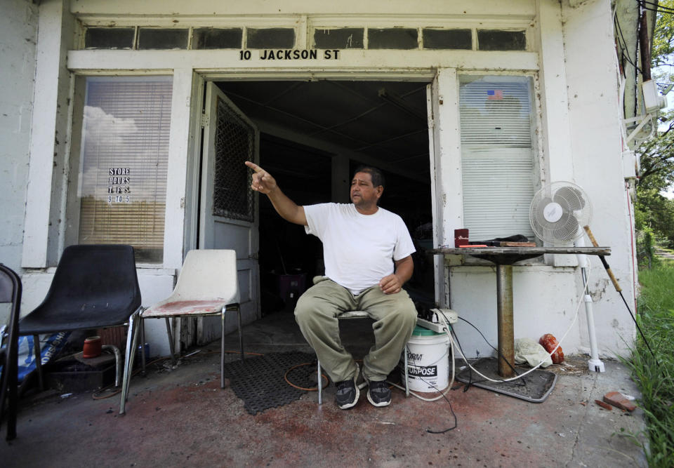 In this July 9, 2019 photo, John Earle gestures while talking outside his second-hand store in Gainesville, Ala. According to Earle, the $2 billion Tennessee-Tombigbee Waterway, which runs through northeast Mississippi and western Alabama, hasn't helped the small town. (AP Photo/Jay Reeves)