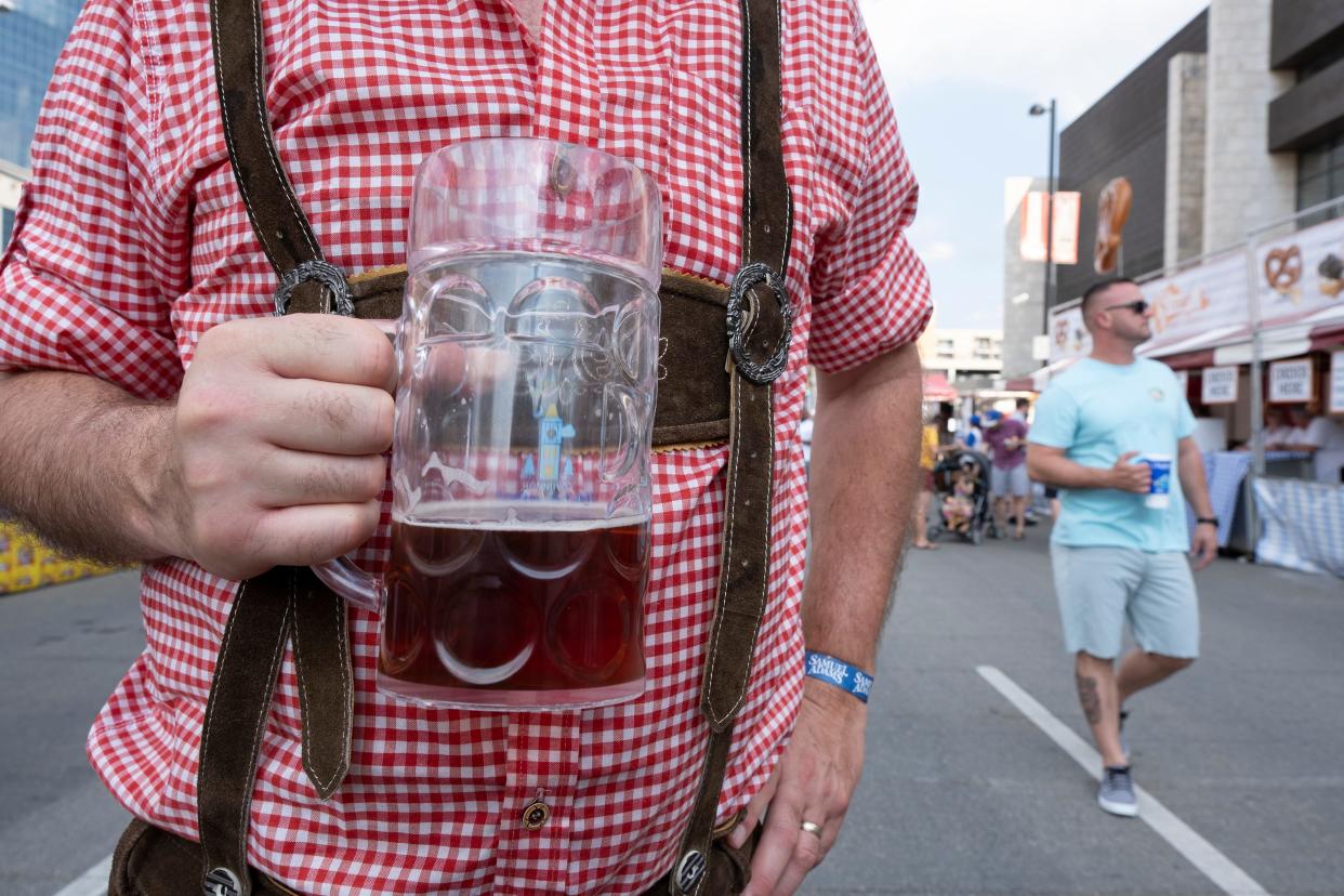 Joe Wood holds his beer stein at the opening day of Oktoberfest Zinzinnati in 2019. This year's celebration runs Sept. 14-17 along Fifth Street in Downtown.