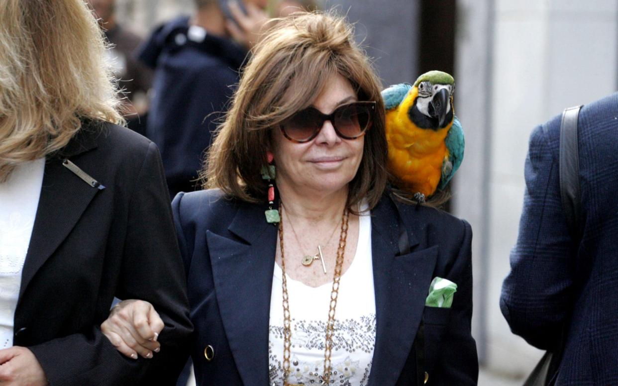 Patrizia Reggiani strolls in Milan with her pet parrot on her shoulder - Eyevine