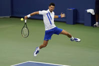 Novak Djokovic, of Serbia, returns a shot to Milos Raonic, of Canada, during the finals of the Western & Southern Open tennis tournament Saturday, Aug. 29, 2020, in New York. (AP Photo/Frank Franklin II)