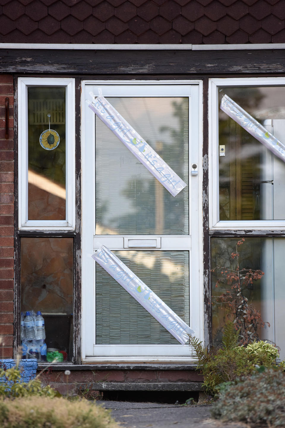 ‘It’s a girl’ banners are displayed across the door and window (Caters)