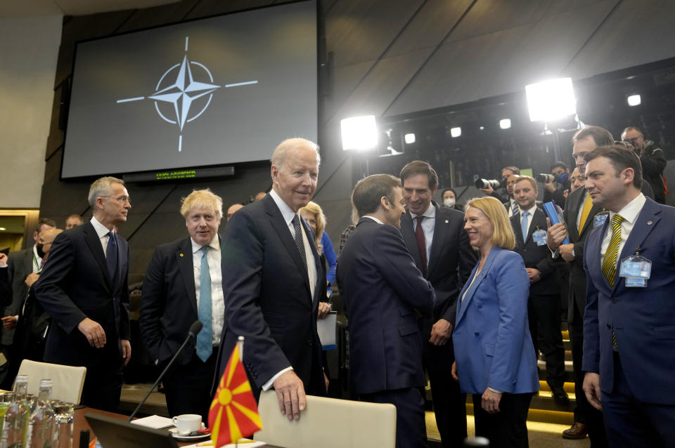 FILE - U.S. President Joe Biden, center, arrives for a round table meeting during an extraordinary NATO summit at NATO headquarters in Brussels, Thursday, March 24, 2022. War has been a catastrophe for Ukraine and a crisis for the globe. One year on, thousands of civilians are dead, and countless buildings have been destroyed. Hundreds of thousands of troops have been killed or wounded on each side. Beyond Ukraine’s borders, the invasion shattered European security, redrew nations’ relations with one another and frayed a tightly woven global economy. (AP Photo/Markus Schreiber, File)