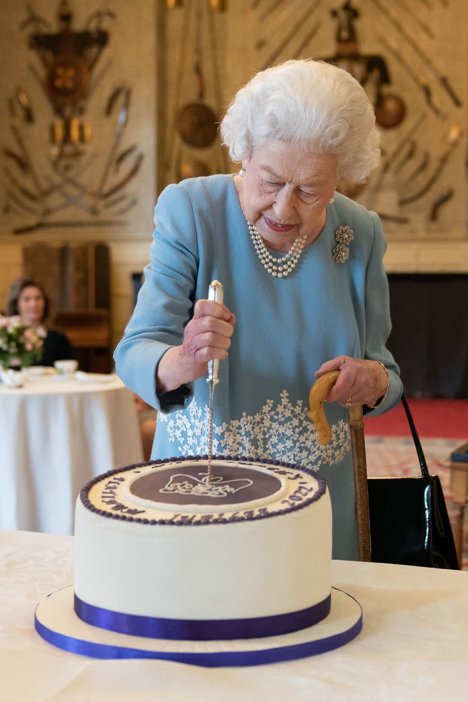 <p>On <a href="https://www.townandcountrymag.com/society/tradition/a38982687/queen-elizabeth-platinum-jubilee-milestone-accession/" rel="nofollow noopener" target="_blank" data-ylk="slk:the day of her 70th anniversary;elm:context_link;itc:0;sec:content-canvas" class="link ">the day of her 70th anniversary</a> on the throne, Queen Elizabeth held a reception in the ballroom of Sandringham House. She cut a cake in a moment that soon went viral, and, as she chatted with her guests, the Queen <a href="https://www.townandcountrymag.com/society/tradition/a39024299/queen-elizabeth-prince-phillip-cane-photos/" rel="nofollow noopener" target="_blank" data-ylk="slk:used a walking stick—which previously belonged to her late husband, Prince Philip;elm:context_link;itc:0;sec:content-canvas" class="link ">used a walking stick—which previously belonged to her late husband, Prince Philip</a>.</p>