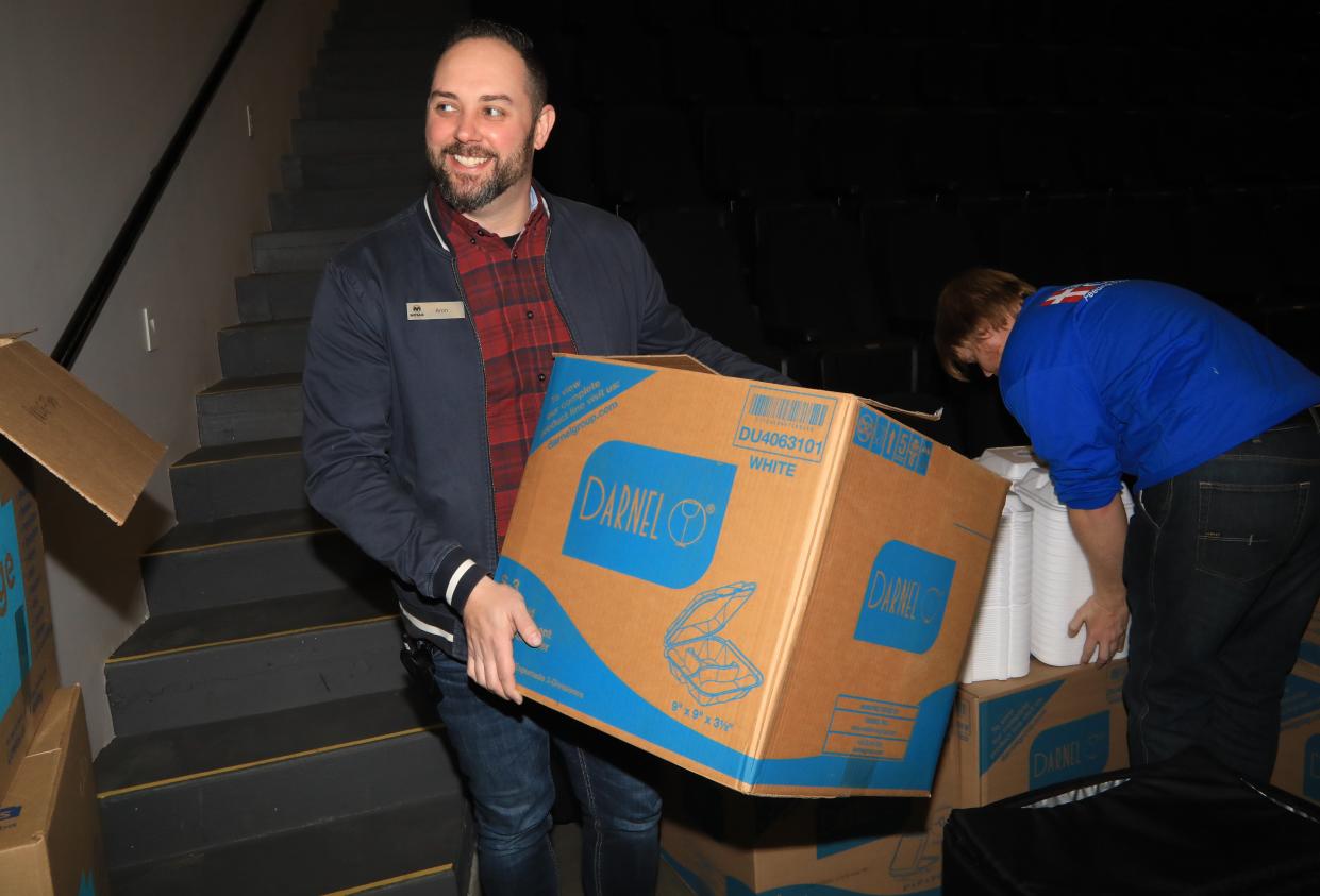 Mosaic Church Next Gen Pastor Aron Maberry carries boxes of supplies at Mosaic Church during tornado recovery efforts in December 2023 in Clarksville, Tenn.