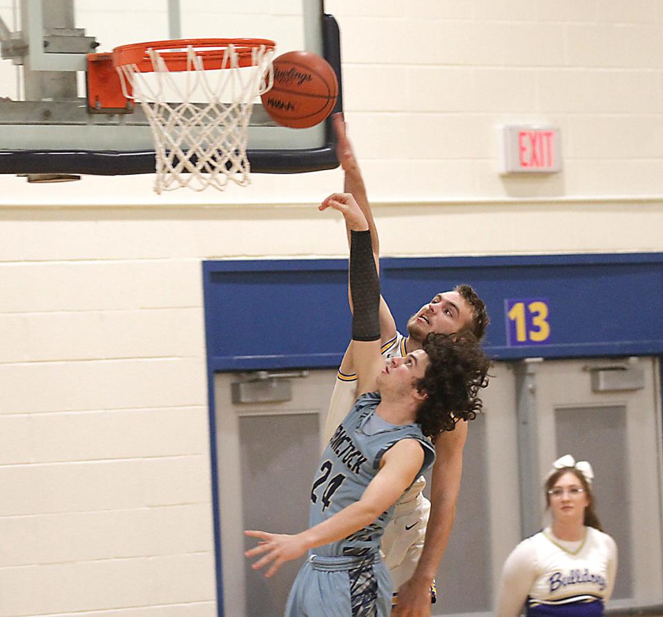 Corey Carpenter blocks a layup attempt from Comstock's Tyler Baker in prep hoops action on Tuesday.