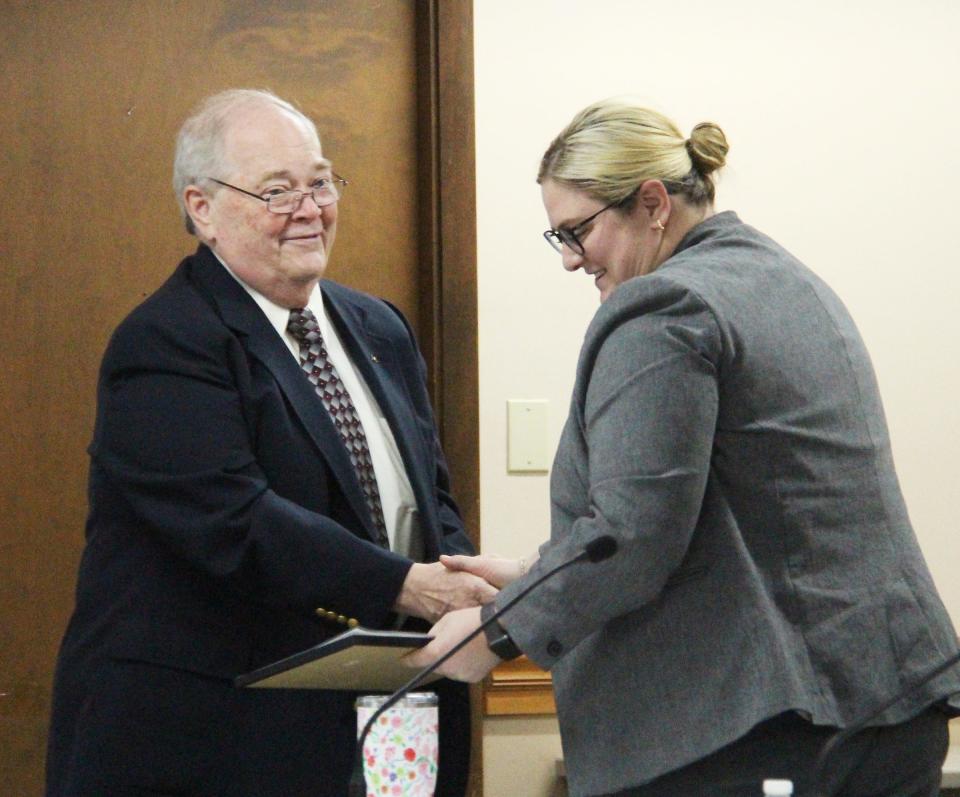 Mayor Bill Alvey, left, presents Alderperson Maggie Clark with a certificate and offers his thanks for her service as a member of the Pontiac City Council at Monday's meeting. Clark is stepping down after having moved out of her ward.